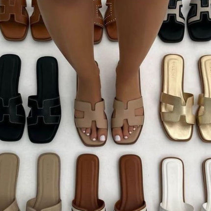 Black sandals styled on an urban street