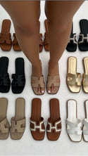 Black sandals styled on an urban street